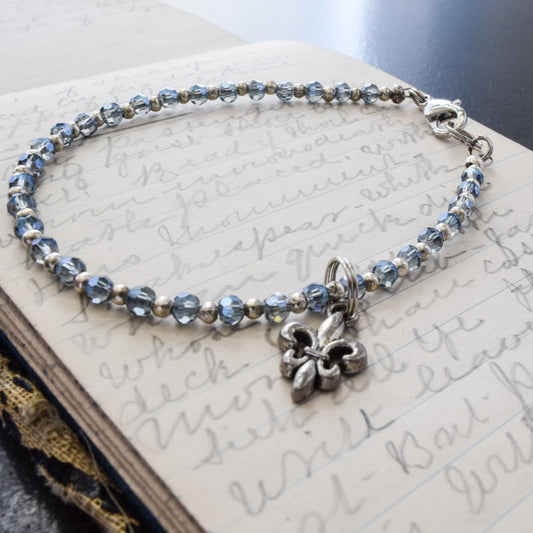 Expressions in Blue, Bracelet with Electro-Plated Aquamarine Crystals, Silver Beads, and an Antiqued Silver Fleur-De-Lei Charm