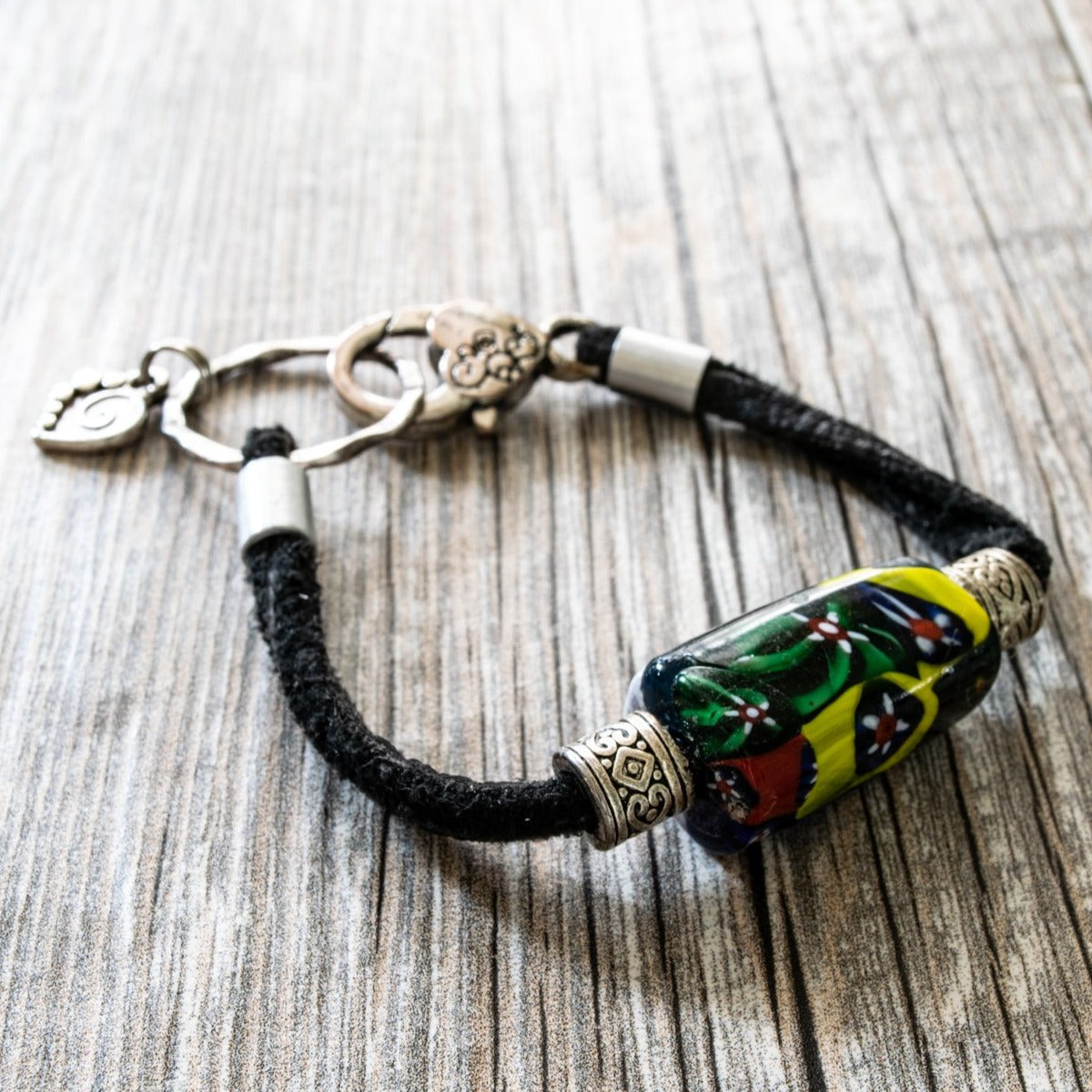 Soft Surrounds, Black Leather Bracelet with Multi-Colored Glass Bead, a Silver Heart, and a Lobster Claw Clasp