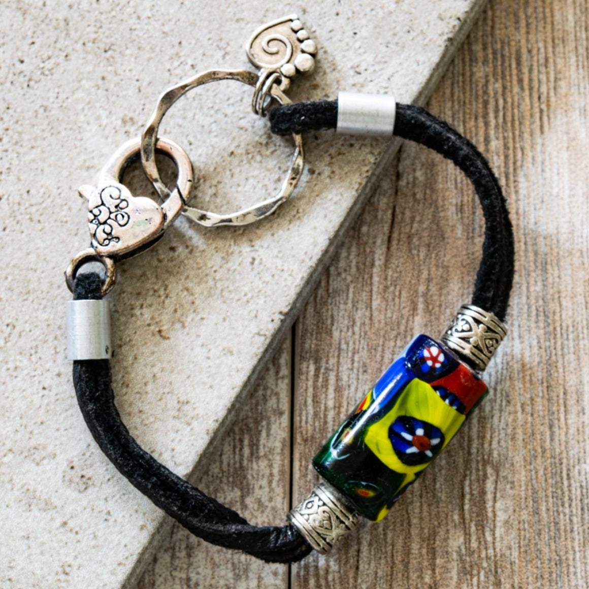 Soft Surrounds, Black Leather Bracelet with Multi-Colored Glass Bead, a Silver Heart, and a Lobster Claw Clasp