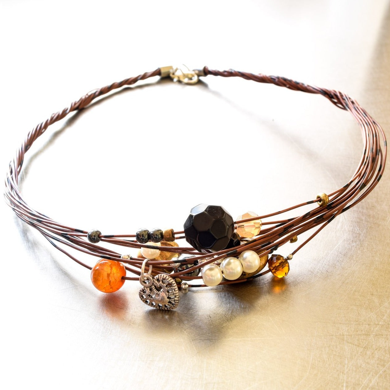 Strands, Brown with Black Wire Necklace with Glass, Stone, and Metallic Beads, and a Heart Charm