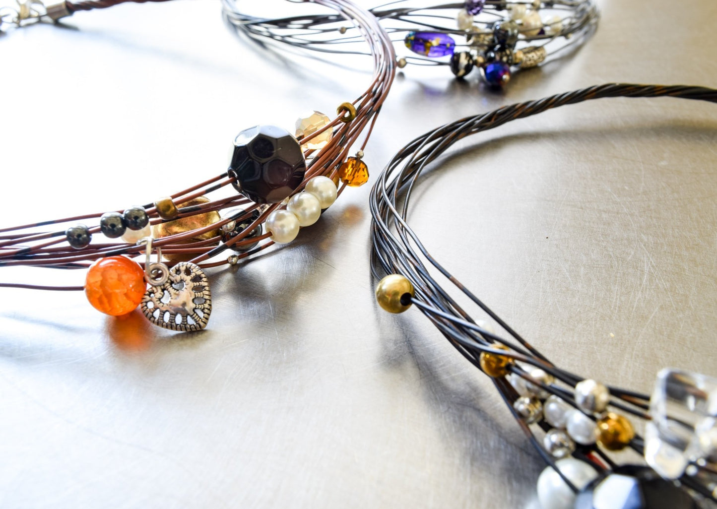 Strands, Brown with Black Wire Necklace with Glass, Stone, and Metallic Beads, and a Heart Charm