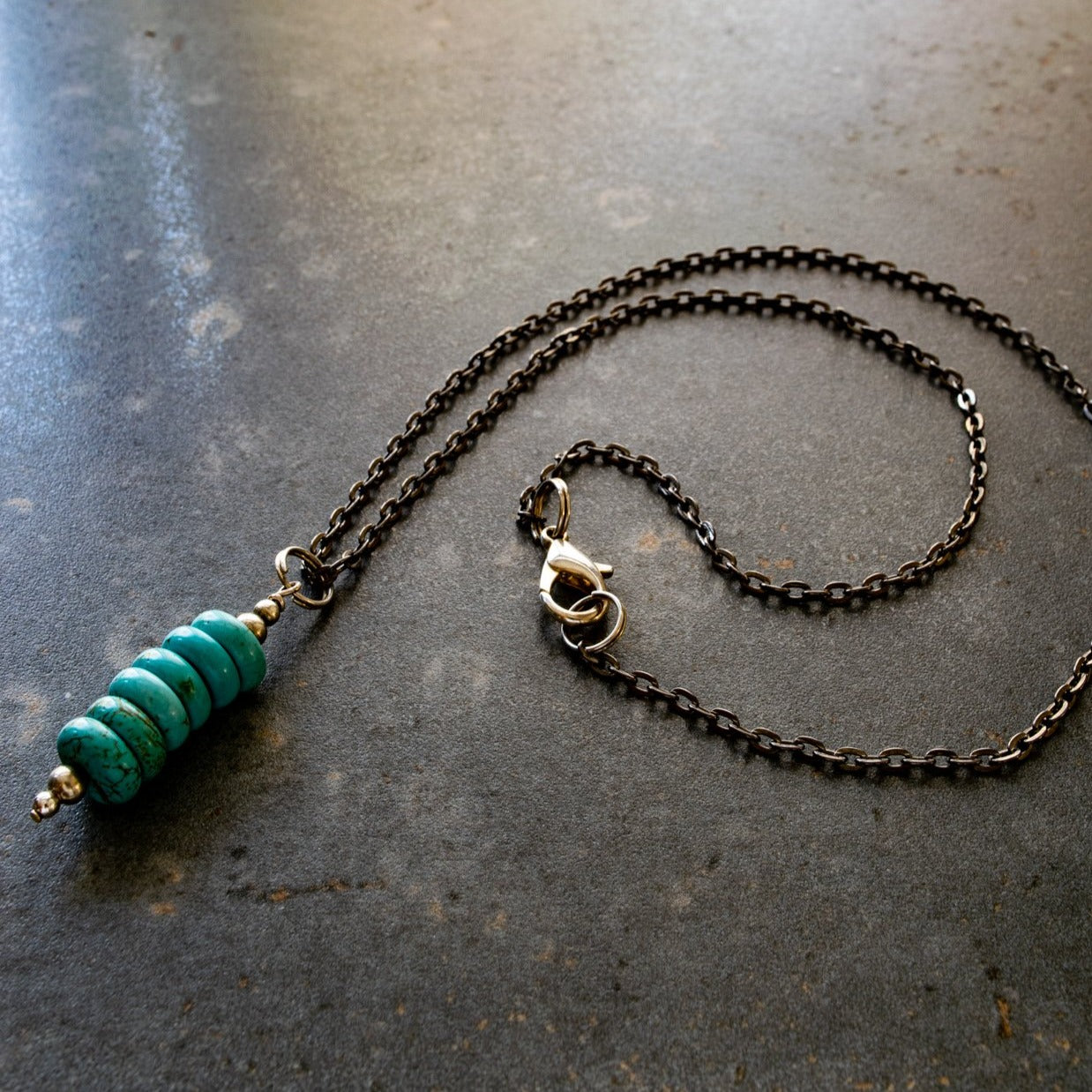 Expressions in Turquoise, 19 inch Stacked Turquoise Pendent on a Gunmetal Necklace