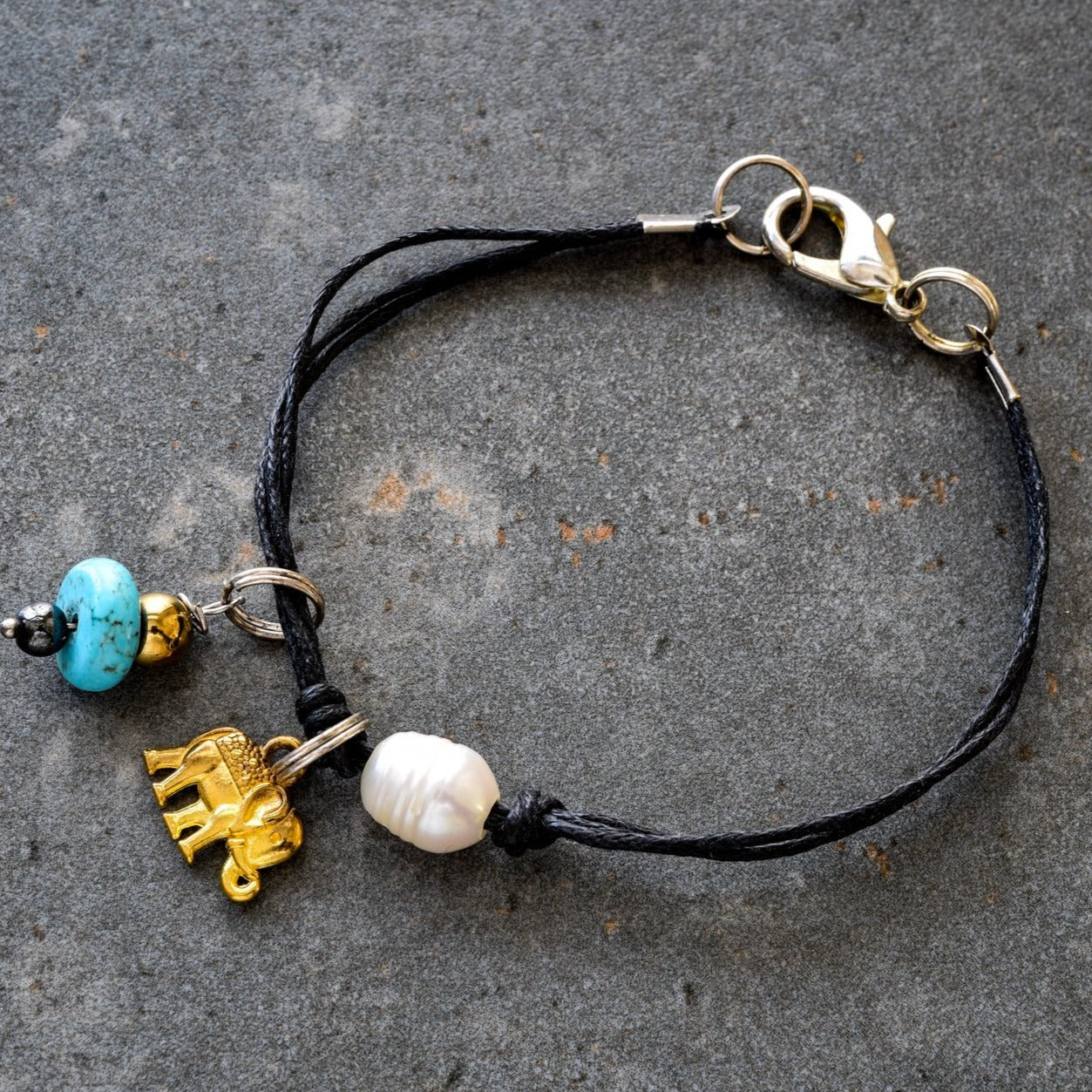 Istanbul, Black Strands Bracelet with a Gold Elephant, Turquoise, and a Fresh Water Pearl