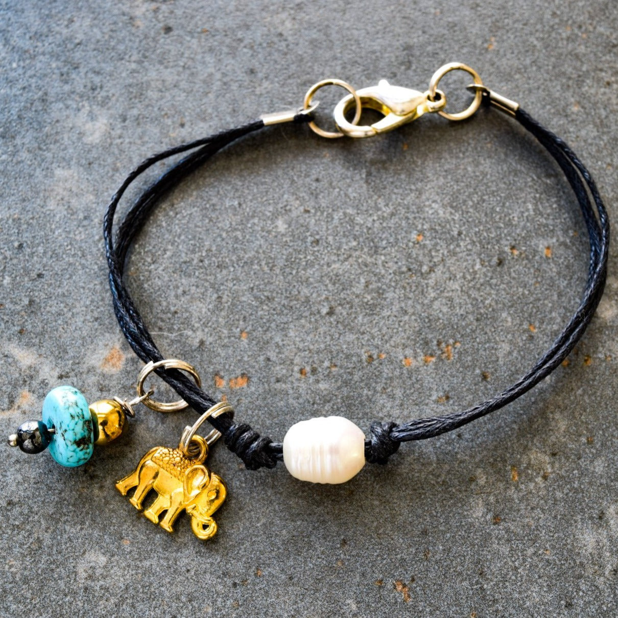 Istanbul, Black Strands Bracelet with a Gold Elephant, Turquoise, and a Fresh Water Pearl